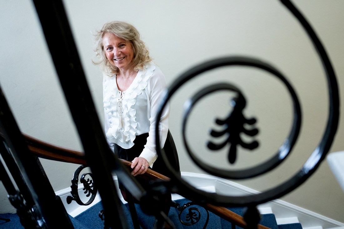 Portrait of Ursula Smartt, who is standing on the stairs of a building in London.